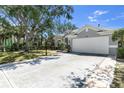 Inviting single-story home showcases a wide driveway, two-car garage, and manicured front yard, perfect for suburban living at 6617 Cheswick St, Sarasota, FL 34243