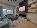 Comfortable living room features a modern fireplace, mounted television, and plush seating at 6875 Beckwith Ave, North Port, FL 34291