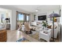 Bright living room boasts comfortable seating, neutral tones, and scenic views at 7019 River Hammock Dr # 306, Bradenton, FL 34212