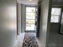 Bright condo entryway features tile floors and open doorway to an adjacent room at 725 Capri Isles Blvd # 217, Venice, FL 34292
