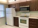 Kitchen features white appliances, modern microwave, and laminate countertops at 725 Capri Isles Blvd # 217, Venice, FL 34292