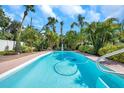 Sparkling pool surrounded by lush tropical foliage, creating a serene outdoor oasis at 7508 9Th N Ave, St Petersburg, FL 33710
