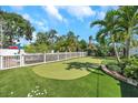 Private putting green with artificial turf, perfect for golf enthusiasts to practice their short game at 7508 9Th N Ave, St Petersburg, FL 33710