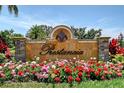 The Prestancia community sign with beautiful flower beds and landscaping creates a welcoming entrance at 7728 Club Ln, Sarasota, FL 34238