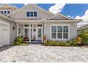 Close-up of a home's exterior with well-manicured landscaping and a welcoming front porch at 8133 Grande Shores Dr, Sarasota, FL 34240