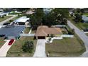 Aerial view of a charming single Gathering home with a brown roof, white perimeter fence and a well manicured yard at 816 Wabash Rd, Venice, FL 34293