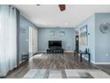 Bright and airy living room featuring wood floors, light blue walls and a front door entry way at 816 Wabash Rd, Venice, FL 34293