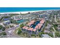 Aerial view of condos close to the beach, tennis courts, and a pond at 1159 Lake House Cir # C120, Sarasota, FL 34242