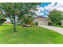 Charming single-Gathering home boasts a lush lawn and mature trees, providing great curb appeal at 12815 24Th Street E Cir, Parrish, FL 34219