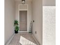 Cozy front porch with a welcome sign, potted plants, and a stylish rug at 1375 Norwalk Ter, Port Charlotte, FL 33953