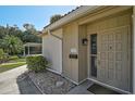 Charming front entrance with a well-maintained landscape and an inviting beige front door at 151 Vista Hermosa Cir # 31C, Sarasota, FL 34242