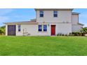 Expansive backyard featuring a well-maintained lawn and a screened in patio at 1824 Woodleaf Hammock Ct, Bradenton, FL 34211