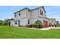 Beautiful side view of a two-story home with a large grassy lawn and well-maintained landscaping at 1824 Woodleaf Hammock Ct, Bradenton, FL 34211