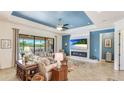 Spacious living room with ample seating, a fireplace, and sliding glass doors to the outdoor patio at 20359 Cristoforo Pl, Venice, FL 34293