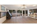 Bright living room with large windows offering views of the front yard, featuring modern decor at 2207 Hickory Ave, Sarasota, FL 34234