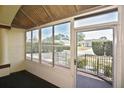 Enclosed front porch with large glass windows allowing ample natural light and an inviting outdoor experience at 2371 Manheim Ave, North Port, FL 34286