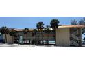 Inviting two-story building with balconies, beachfront access, and lush palm trees at 2412 N Gulf Dr # 119, Bradenton Beach, FL 34217