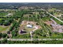 Aerial view showcasing the property lines of a beautiful home site with a pond and natural surroundings at 27510 67Th E Ave, Myakka City, FL 34251