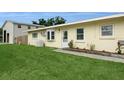 Cozy single-story home with a green lawn and a welcoming front entrance at 2804 W Mark Dr, Sarasota, FL 34232