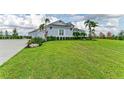 Beautiful single-story home with a lush green lawn, landscaping, and well maintained exterior at 3518 Recurve Cir, Sarasota, FL 34240