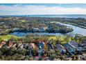 Gorgeous aerial view showcases a home with mature trees near a golf course and waterfront at 3521 Fair Oaks Ln, Longboat Key, FL 34228