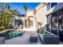Private pool and patio area, perfect for entertaining or relaxing, with stylish outdoor furniture at 3521 Fair Oaks Ln, Longboat Key, FL 34228