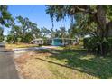 Charming single-story home with a covered parking area, and large trees at 3619 Elm St, Ellenton, FL 34222