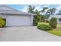 Spacious two-car garage with a large concrete driveway and manicured lawn at 3662 Bonaventure Ct, Sarasota, FL 34243