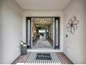 Open entryway featuring a decorative rug, black trimmed doorway, and views of the living room at 3679 Santa Caterina Blvd, Bradenton, FL 34211