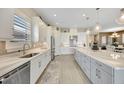 Bright kitchen features white cabinets, stainless steel appliances, an island, and lots of countertop space at 3679 Santa Caterina Blvd, Bradenton, FL 34211