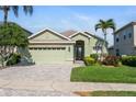 Charming one-story home featuring a two-car garage, lush lawn, and delightful landscaping at 3740 Summerwind Cir, Bradenton, FL 34209