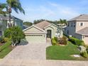 Inviting single-Gathering home boasts mature trees, lush landscaping, and a convenient two-car garage at 3740 Summerwind Cir, Bradenton, FL 34209