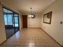 Spacious dining room with tile floors and sliding glass doors at 3957 Bearded Oaks Ct, Sarasota, FL 34232
