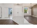 Bright foyer featuring tile flooring, neutral walls, and views into living spaces at 4063 Westbourne Cir, Sarasota, FL 34238