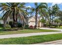 Beautiful single-story home with a well-kept lawn and mature landscaping at 4063 Westbourne Cir, Sarasota, FL 34238
