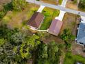 Aerial view showcasing the home's layout, detached garage, and proximity to lush greenery at 4466 Manila Ave, North Port, FL 34288