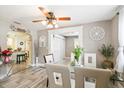 Bright dining room with wood-look tile flooring and a glass-top table with seating for six at 4922 18Th E St, Bradenton, FL 34203