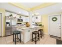 Well-lit kitchen featuring white cabinets, granite countertops, stainless steel appliances, and island seating at 4922 18Th E St, Bradenton, FL 34203