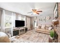Inviting living room featuring wood-look tile flooring, a brick fireplace, and stylish decor at 4922 18Th E St, Bradenton, FL 34203