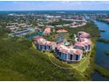 An aerial shot of the condo community, highlighting its proximity to waterways and surrounding landscape at 5430 Eagles Point Cir # 101, Sarasota, FL 34231