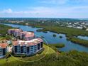 An aerial view of the condo complex, showcasing its waterfront location and surrounding greenery at 5430 Eagles Point Cir # 101, Sarasota, FL 34231
