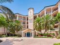 The building's exterior boasts a stucco facade, beautiful landscaping, and a welcoming entrance at 5430 Eagles Point Cir # 101, Sarasota, FL 34231
