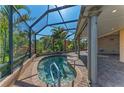 Relaxing screened-in spa with brick pavers and plenty of room for entertaining with lush tropical landscaping at 5439 74Th E Pl, Ellenton, FL 34222
