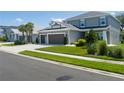 Charming home featuring a three-car garage, lush lawn, and well maintained landscaping at 6017 Maidenstone Way, Palmetto, FL 34221