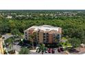 Stunning aerial view of the building and its lush green surroundings with a golf course nearby at 6465 Watercrest Way # 404, Lakewood Ranch, FL 34202