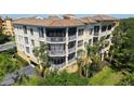 Exterior view of a building featuring multiple screened lanais with great natural light and landscaping at 6465 Watercrest Way # 404, Lakewood Ranch, FL 34202