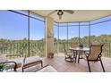 Relaxing screened lanai with comfortable seating, a table and views of the lush surroundings at 6465 Watercrest Way # 404, Lakewood Ranch, FL 34202