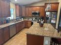Beautiful kitchen with stainless steel appliances, an island, and granite countertops at 7286 Mineola Rd, Englewood, FL 34224