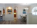 Cozy dining area with wood floors, chandelier, and large window at 7424 Arrowhead Run, Lakewood Ranch, FL 34202