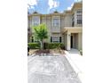 Inviting townhome exterior with a well-manicured lawn and private parking at 7593 Plantation Cir, Bradenton, FL 34201